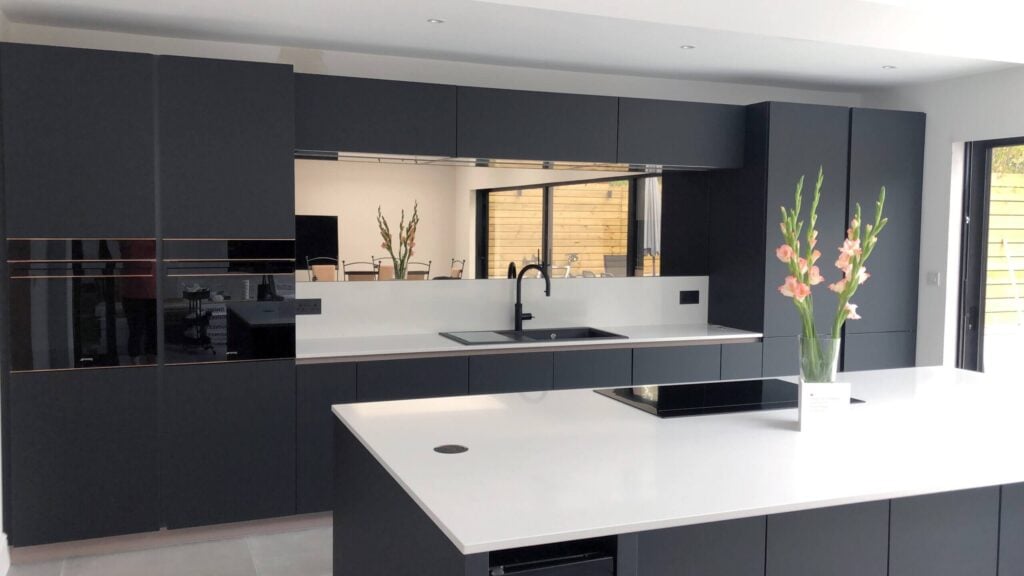 Dark grey kitchen with combination of natural wood and stone